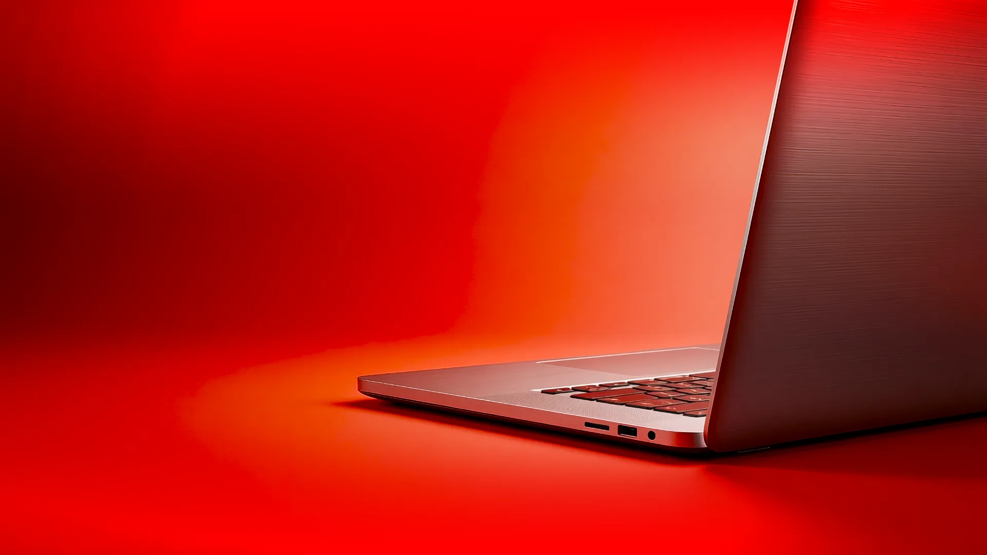 Modern laptop on red gradient background